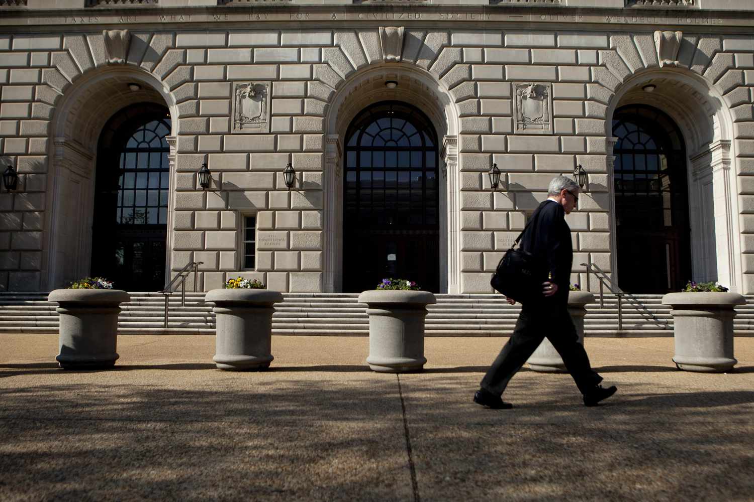 Man walks past the IRS building in Washington D.C.