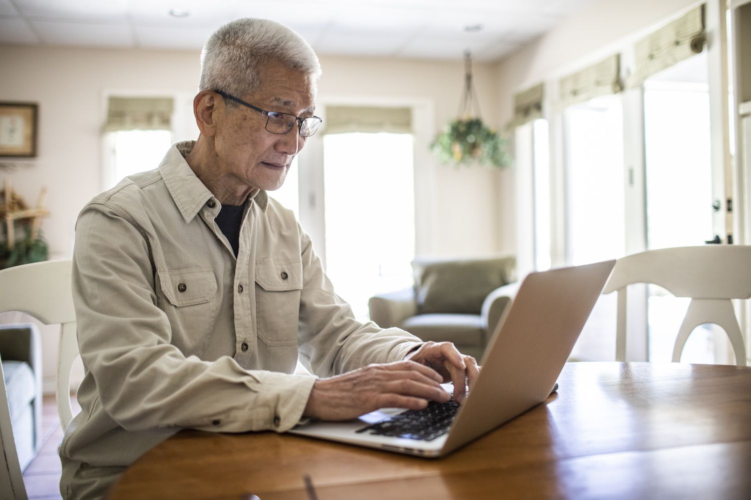 Senior Asian man using laptop
