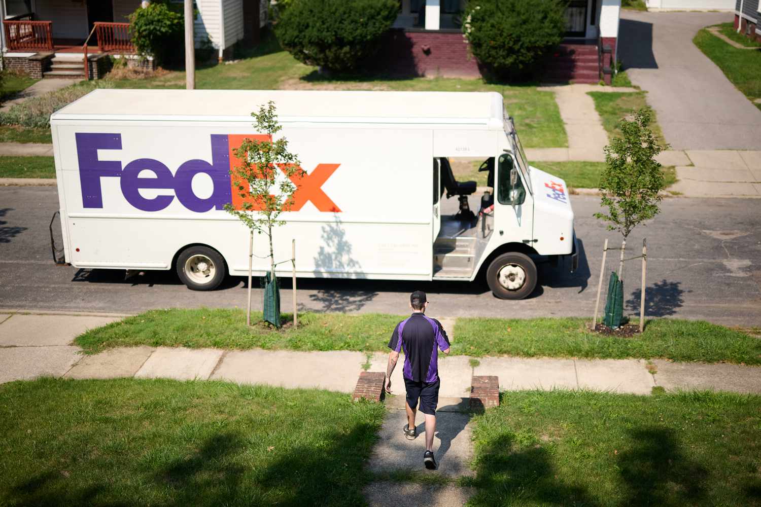 A driver makes a delivery from a FedEx truck to a home in Middleburg Heights, Ohio, on Sept. 13, 2024