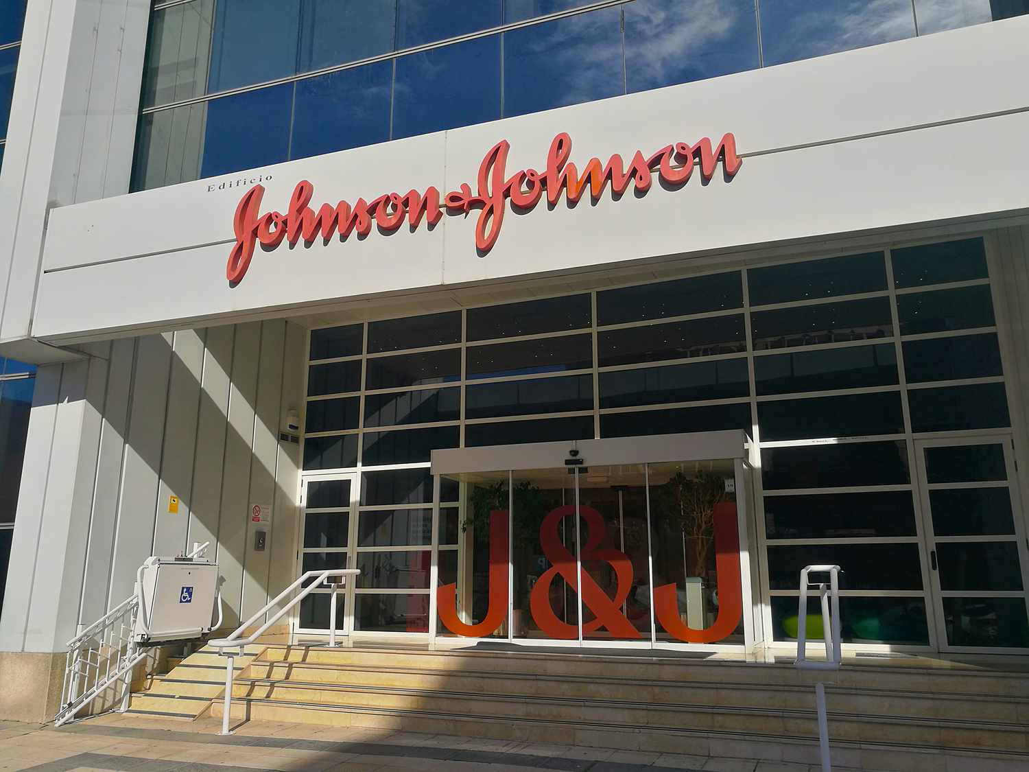 The Johnson & Johnson logo is seen above the entrance to an office building.