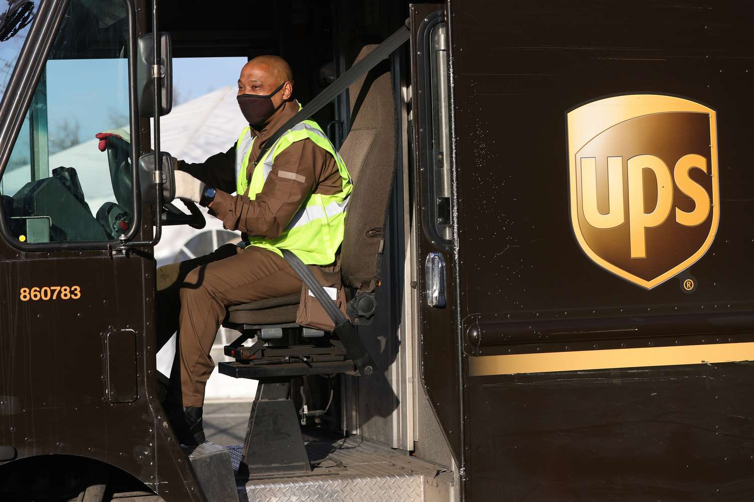 UPS delivery driver driving a UPS truck