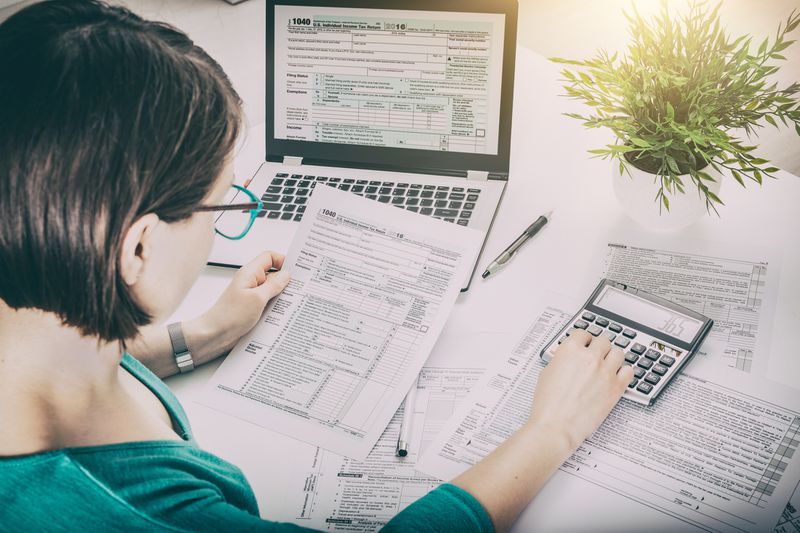 Woman doing taxes at computer