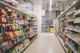 The snack aisle is shown in a supermarket. 