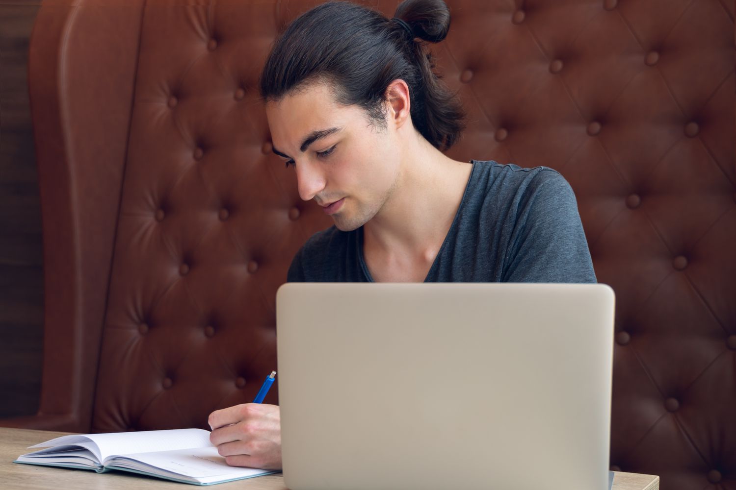 Student with notebook and laptop