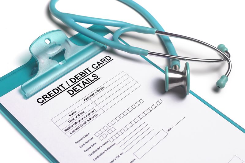 a stethoscope sitting on a form to take patient's credit card payment details