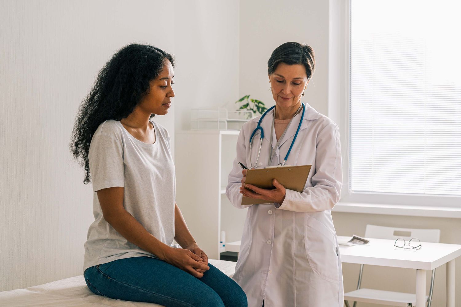 Female patient visiting doctor office telling about symptoms