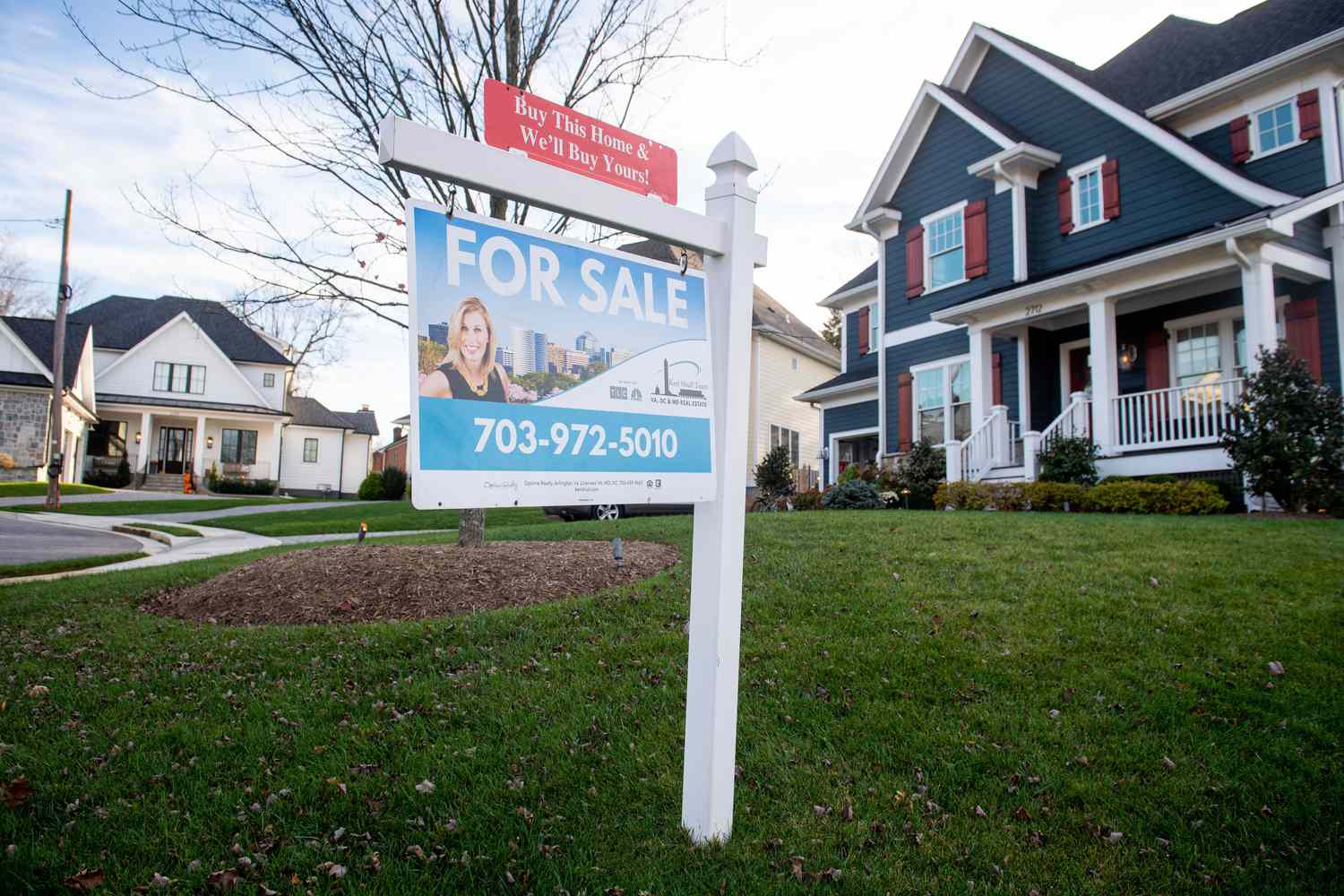 House with a For Sale sign in front of it