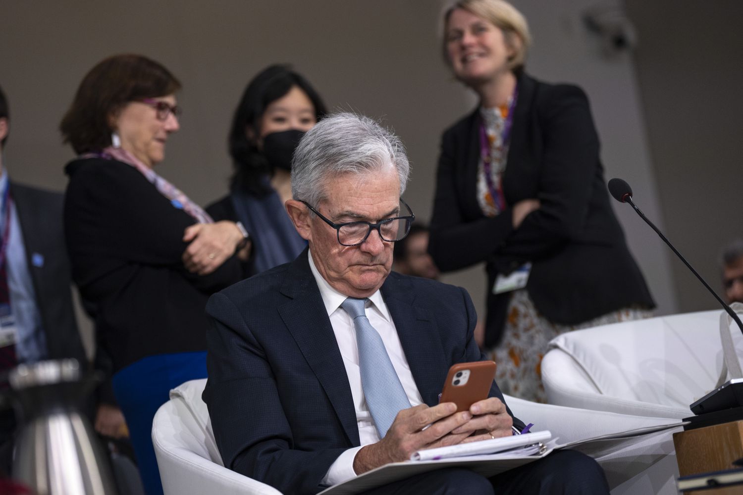 Chair of the U.S. Federal Reserve Jerome Powell checks his phone during a meeting of the IMFC (International Monetary and Financial Committee) at the IMF and World Bank Annual Meetings at IMF headquarters, October 14, 2022 in Washington, DC