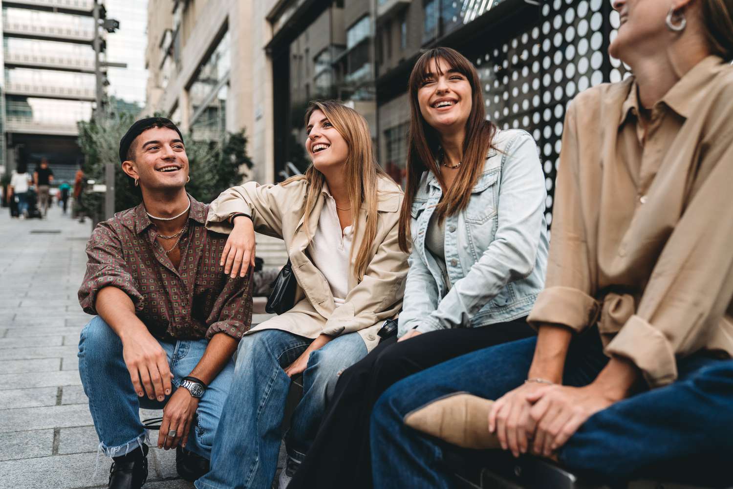 Four young people talk together in the city