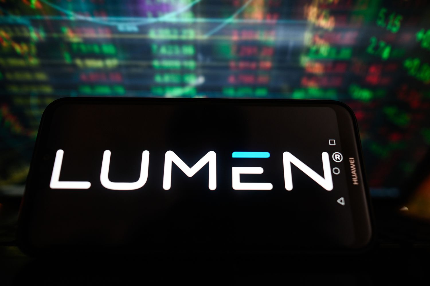 A Lumen logo is displayed on a smartphone with stock market percentages in the background