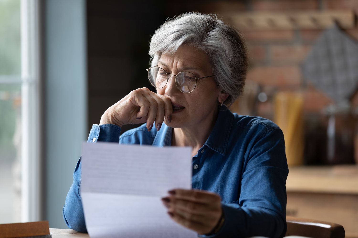 Woman reading a document at home