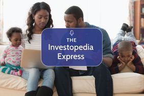 African American family sitting on the couch with a laptop discussing finances