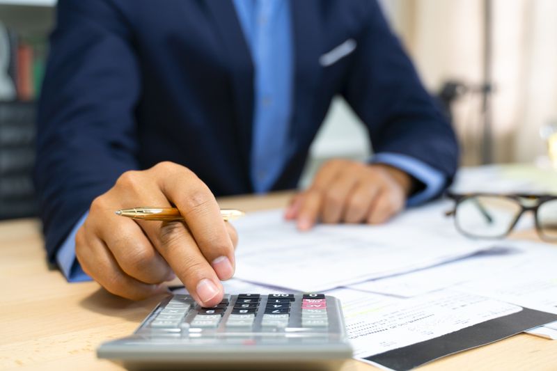 Hands of bank officer calculating loans