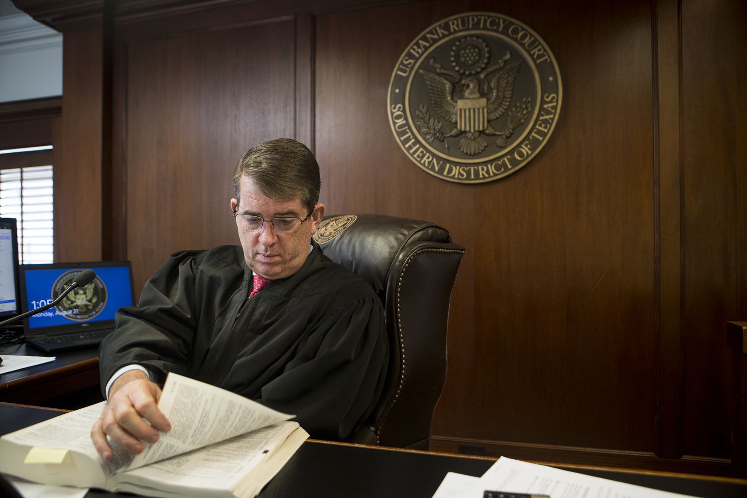 Chief United States Bankruptcy Judge David R. Jones hears closing arguments via a computer connection in his empty courtroom at the Bob Casey Federal Courthouse on Monday, Aug. 31, 2020 in Houston. Judge Jones has built the local court into one of the busiest in the nation, one that handles a number of complex bankruptcies.