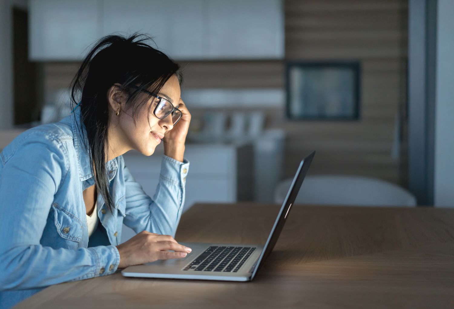 Latino woman looking at laptop