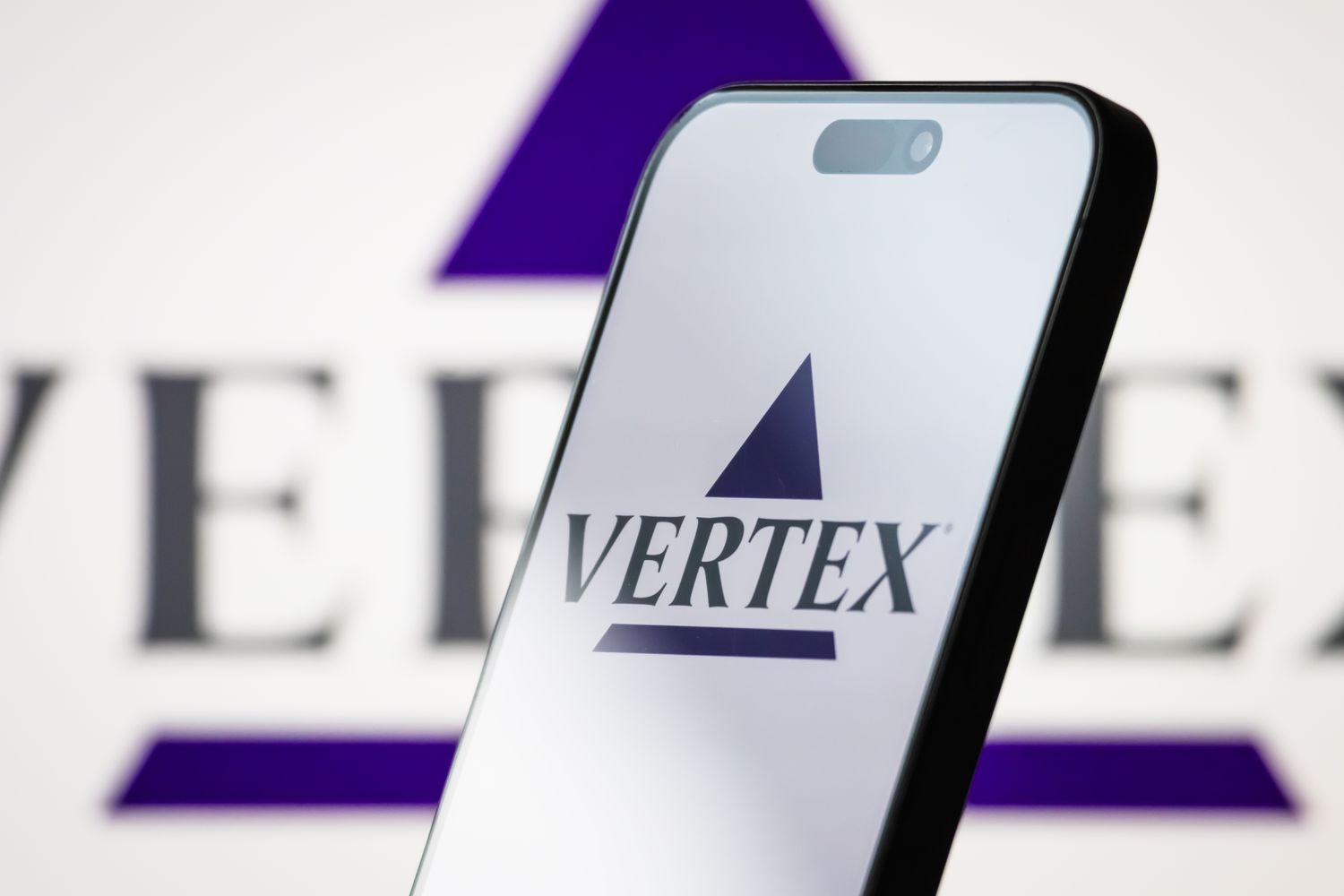 The logo of Vertex Pharmaceuticals Incorporated is displayed on a smartphone screen, with the company's branding visible in the background