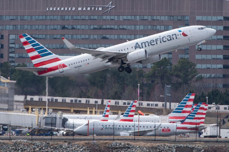 A Boeing 737 flown by American Airlines passes by the Lockheed Martin building