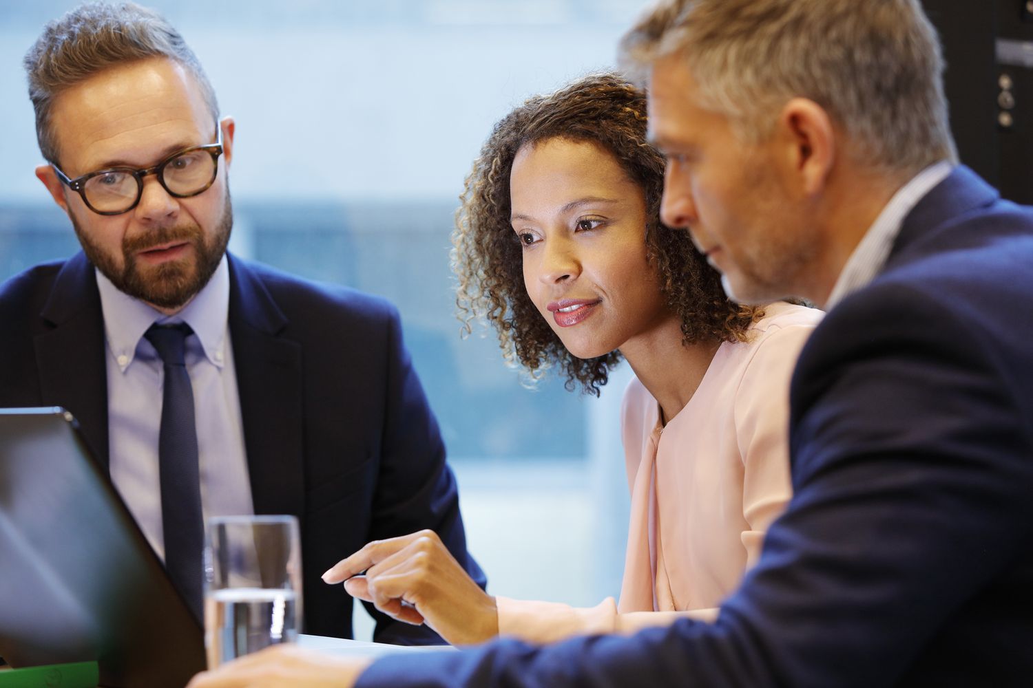 Three investment bank underwriters work on setting underwriting terms for an upcoming initial public offering. 