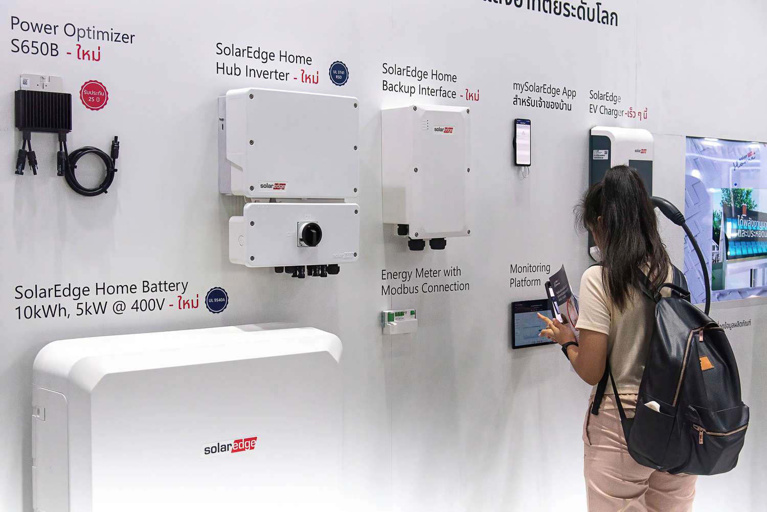 Person looking at a SolarEdge display at an ASEAN Sustainable Energy event in Bangkok in 2023