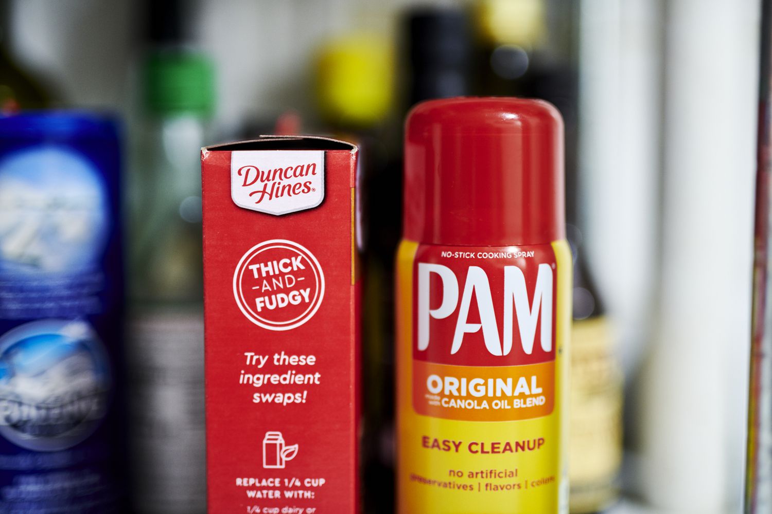 A box of Duncan Hines brownie mix sits next to a bottle of Pam cooking spray