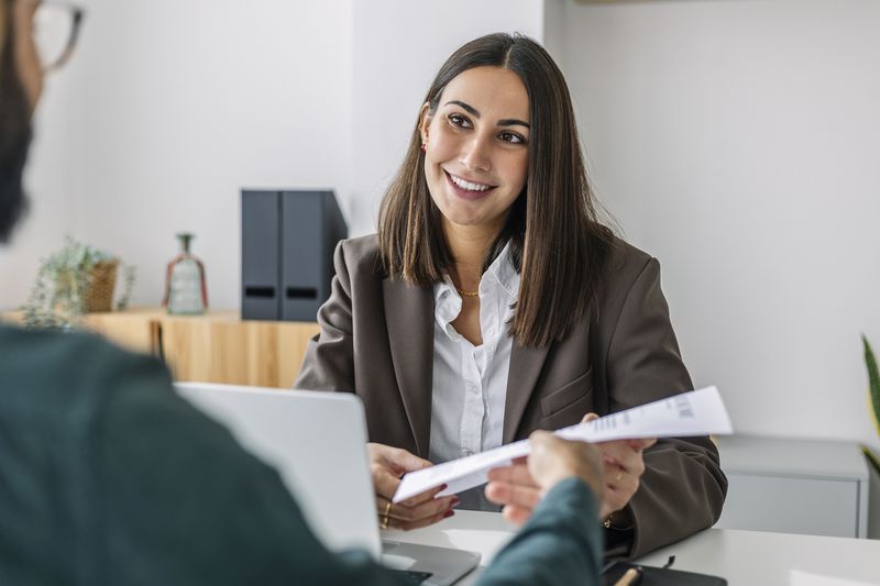A woman accepts documents.