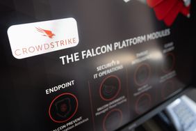 A screen displays the CrowdStrike logo.