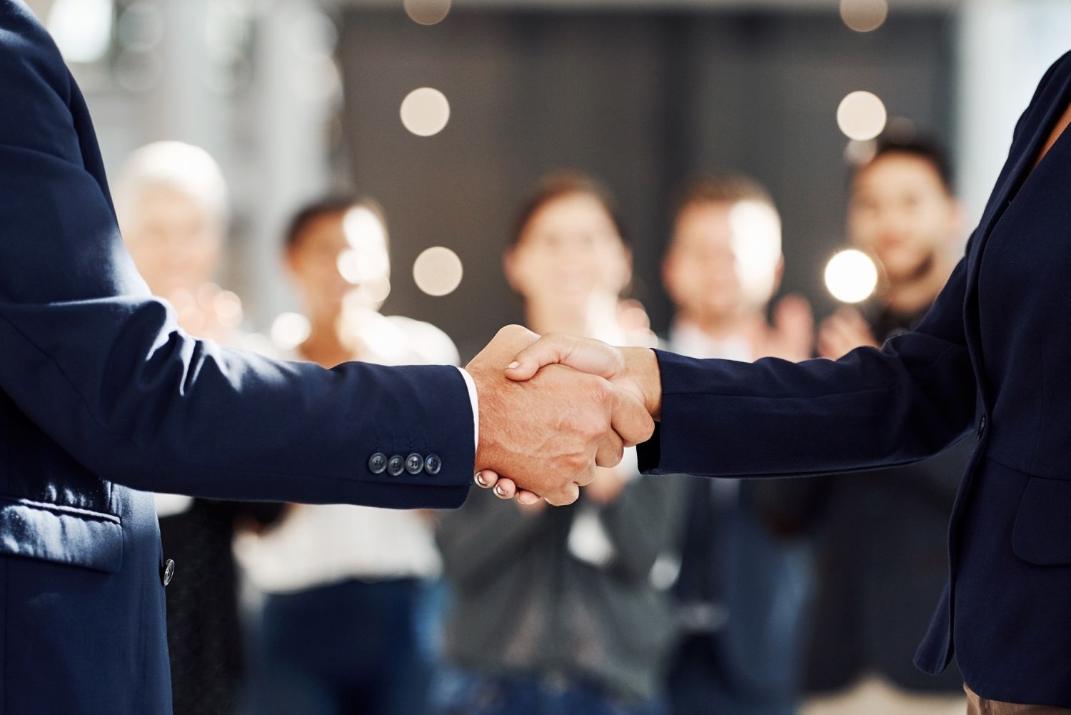 A City Manager and a bank representative shake hand to the applause of a crowd after finalizing a zero basis risk swap for municipal project funding.