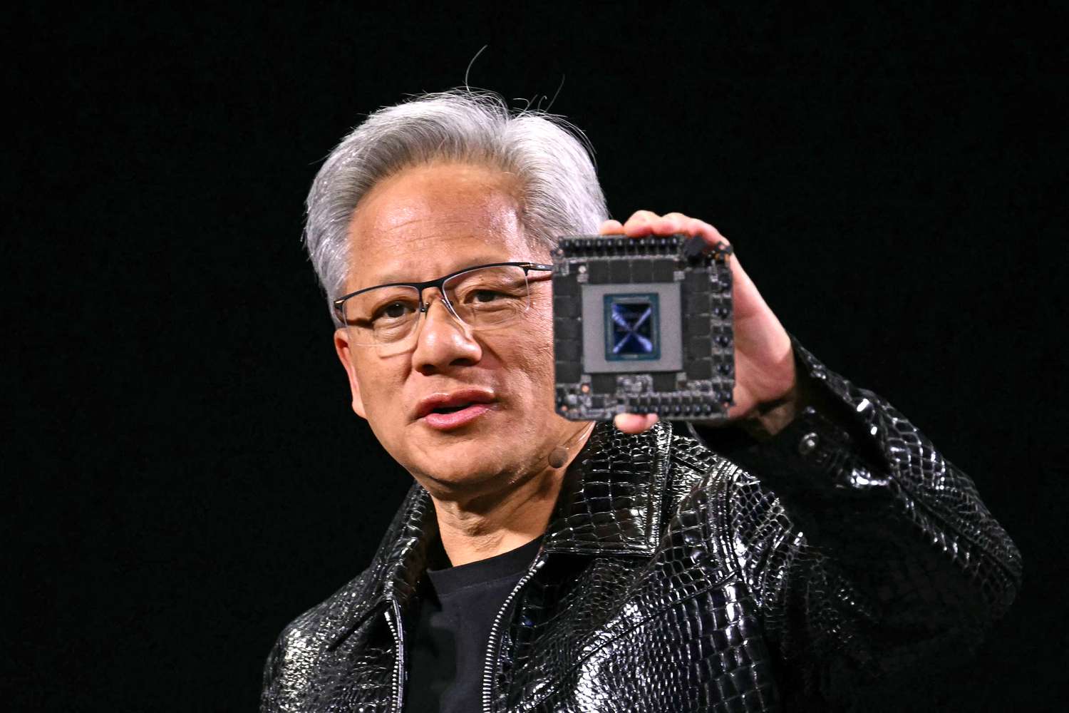 Nvidia CEO Jensen Huang holds a chip at CES.