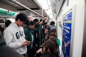 Commuters ride a 4 train in New York, US, on Wednesday, March 19, 2025.