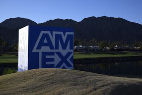 The American Express "AmEx" logo is seen on a large cube advertisement on a golf course.