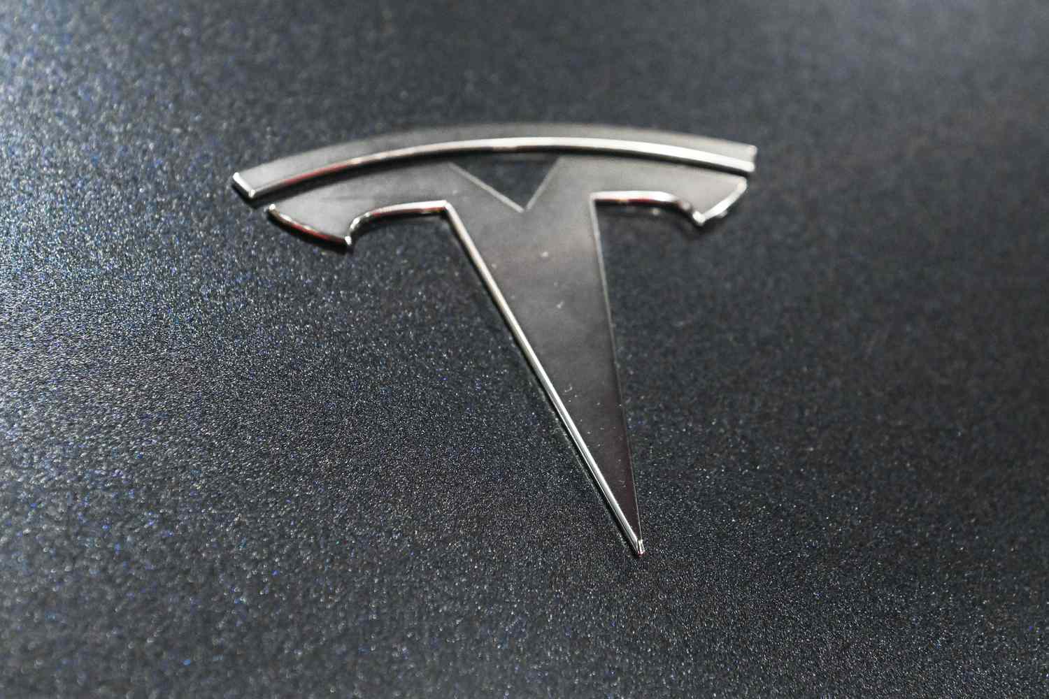 The Tesla logo displayed on a Tesla vehicle.
