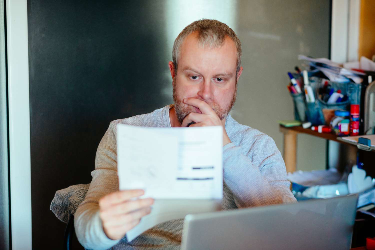A man looking worried looking over bills