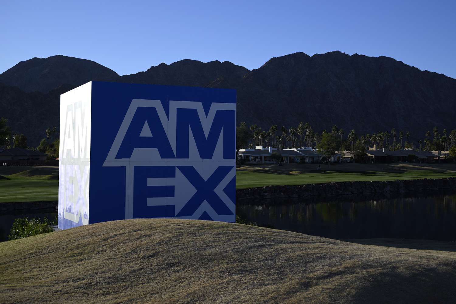 The American Express "AmEx" logo is seen on a large cube advertisement on a golf course.