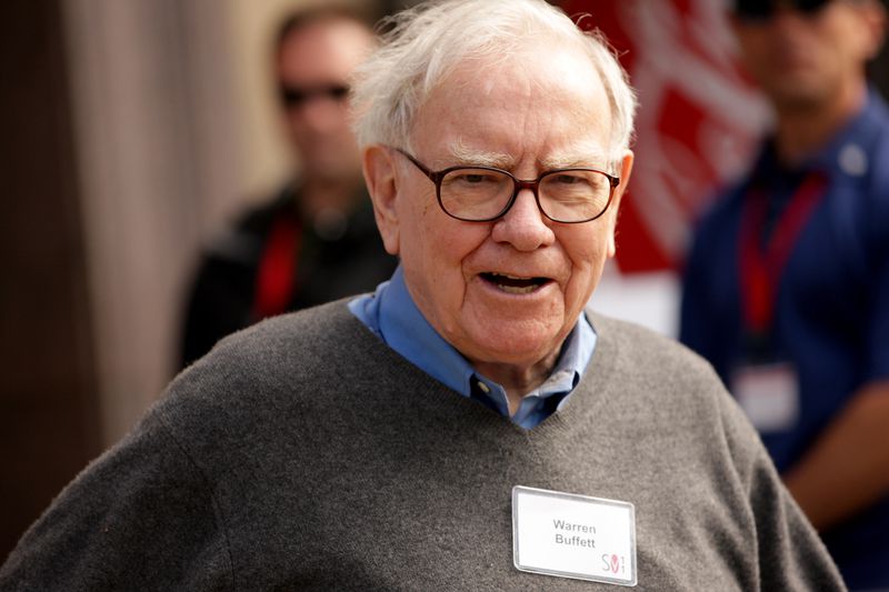 Warren Buffett smiling at camera.