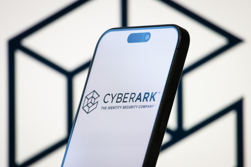 Smartphone screen displaying 'CyberArk, The Identity Security Company' logo, with a geometric design in the background