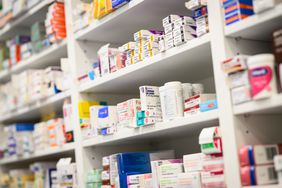 Boxes of medication are seen on the shelves of a pharmacy.