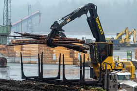 A worker loads logs onto a truck at the Western Forest Products Inc. Ladysmith Log Sort in Ladysmith, British Columbia, Canada, on Tuesday, Feb. 18, 2025. 