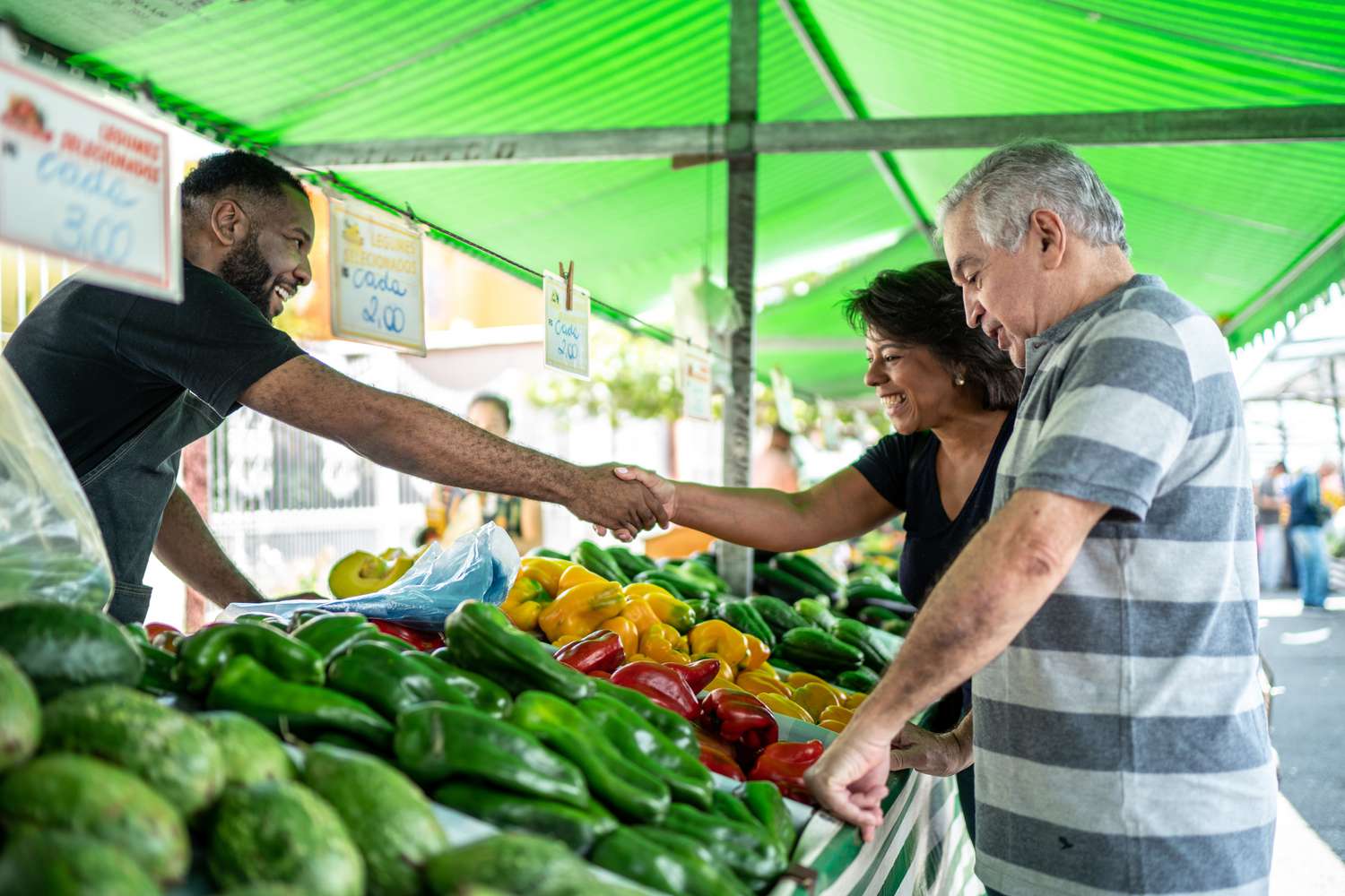 Salesman greeting customers on a street market