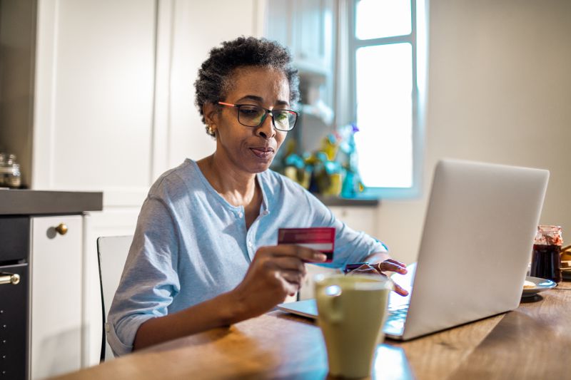 A woman shops online with a credit card.