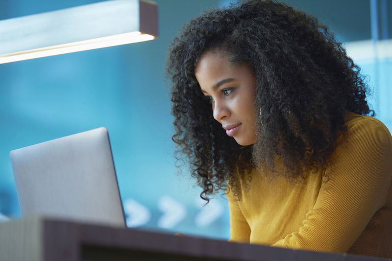 Young Woman on Laptop in Office