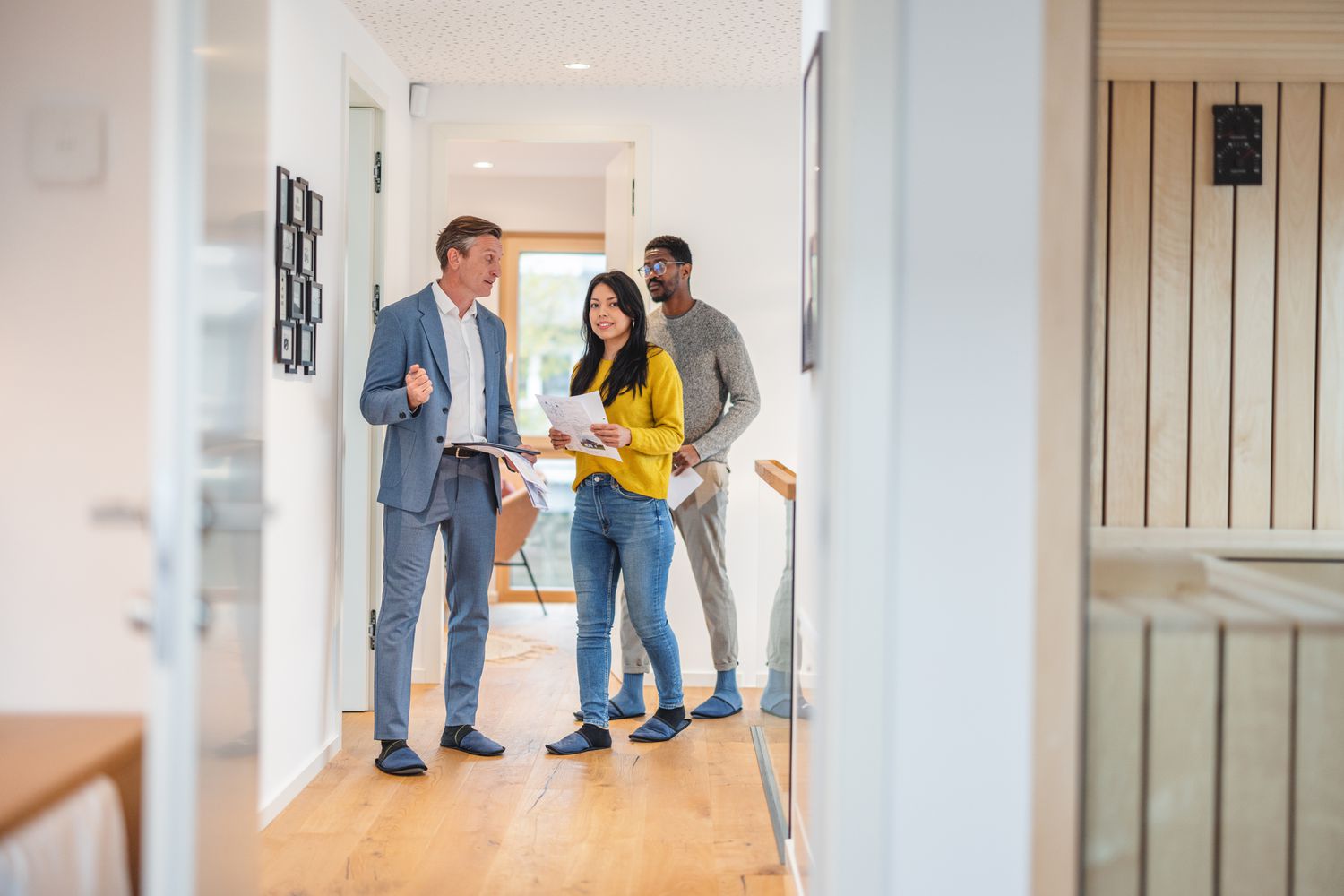 Real estate agent touring a house with a couple