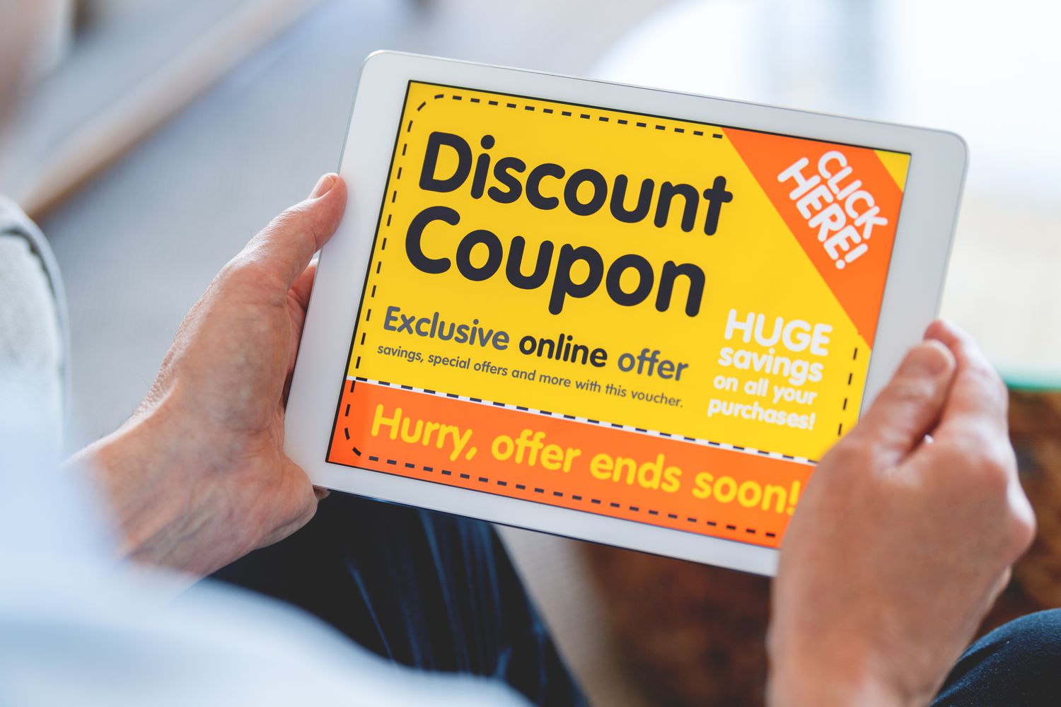 A person holds a pad displaying an advertisment tailored to target online shoppers.