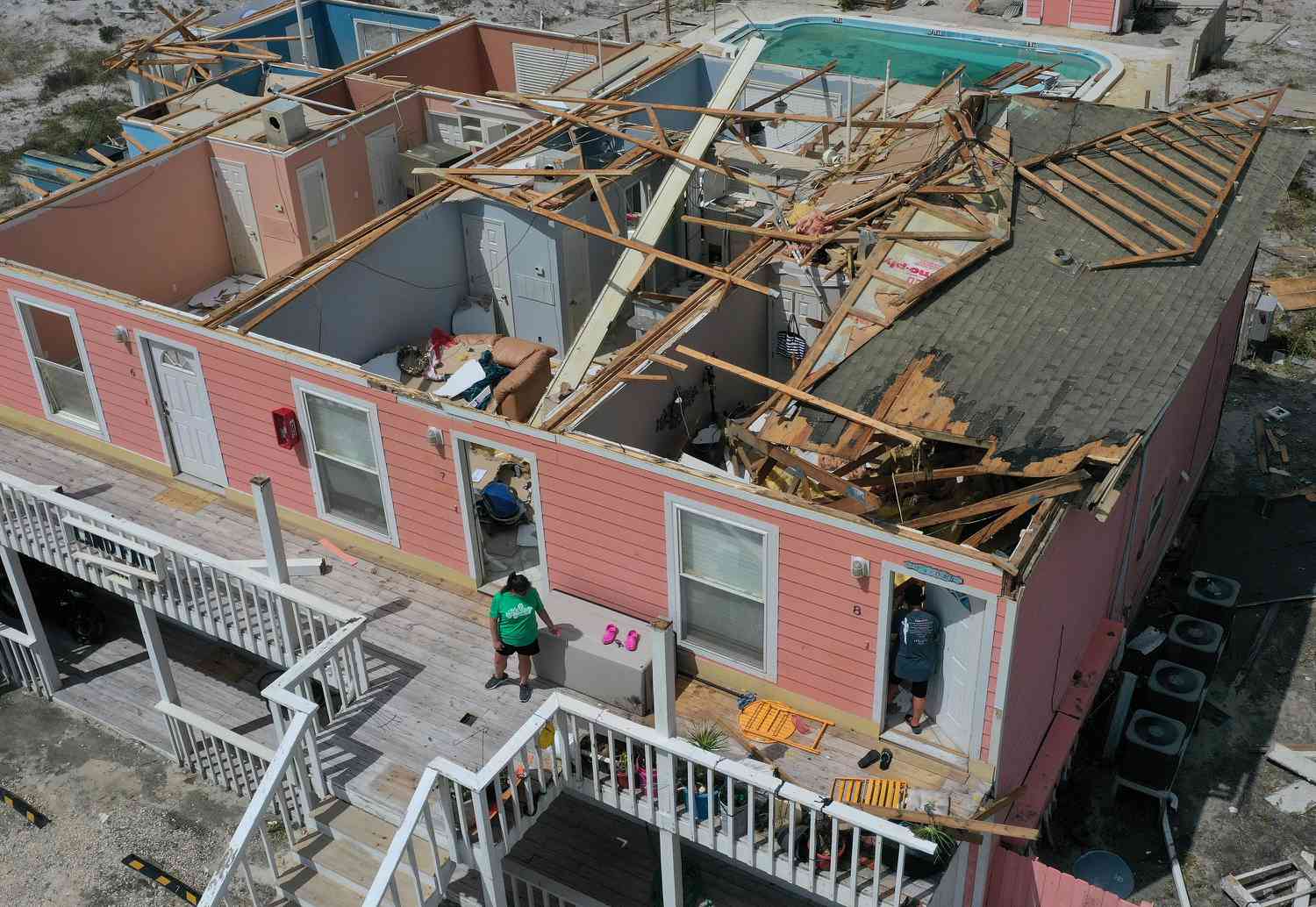  An aerial view from a drone shows Jamie Cade (L) waiting as her mother Jody Wright walks into her damaged apartment after the roof was damaged when Hurricane Sally passed through the area on September 17, 2020 in Perdido Key, Florida. 