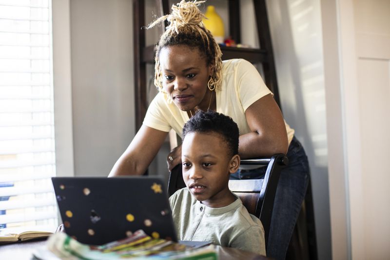 Mother reading about 529 strategies that can maximize student aid options for her son