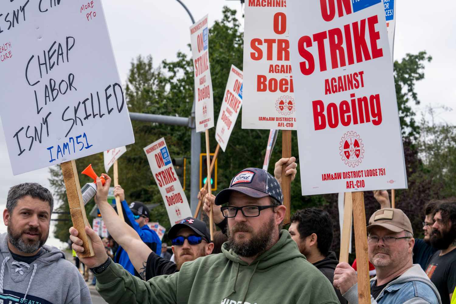 Workers with picket signs outside the Boeing Co. manufacturing facility during a strike in Everett, Washington, US, on Friday, Sept. 13, 2024. 