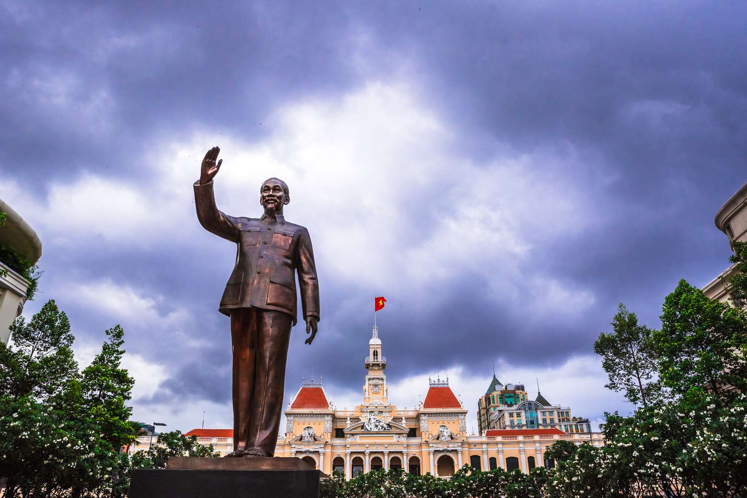 The statue of Ho Chi Minh in Ho Chi Minh City, Vietnam. In the background is the town hall building.