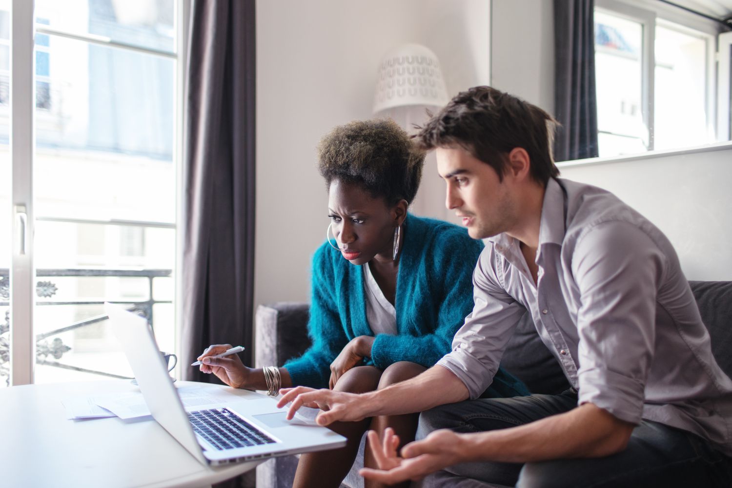 Young couple studying laptop together