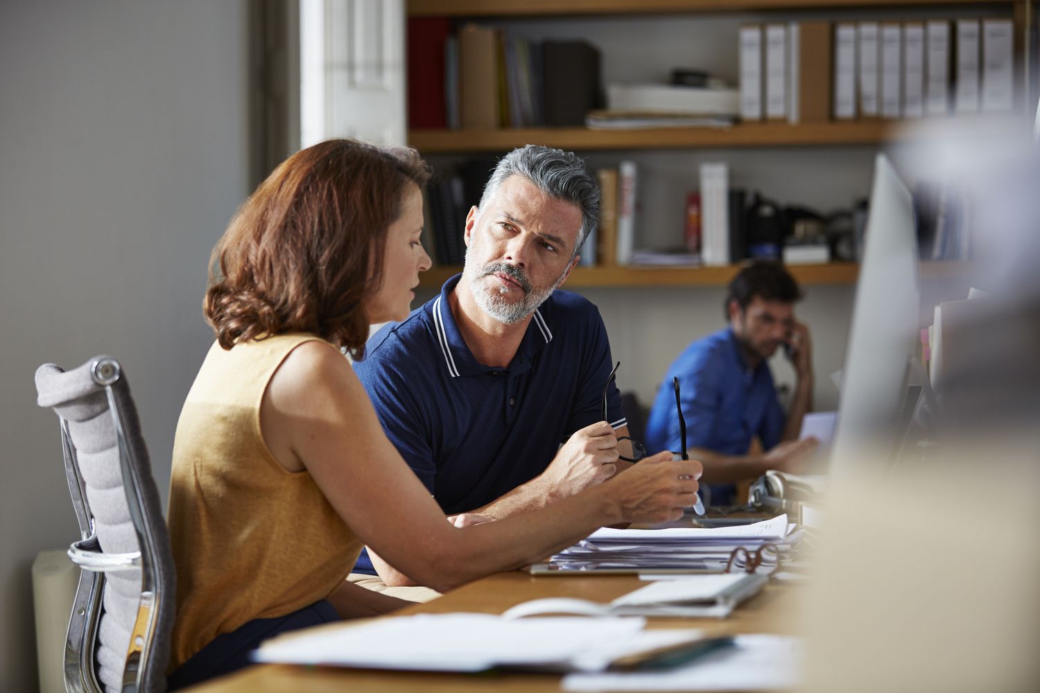 People discussing finances over paperwork