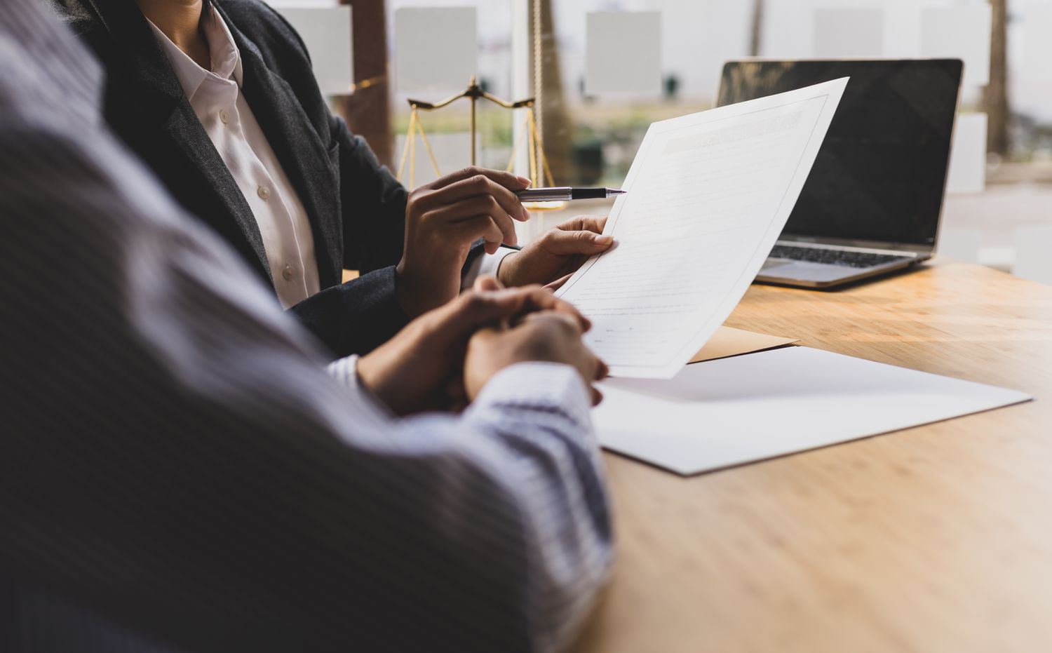 Lawyer is checking documents with client and giving advice to avoid bona fide error.