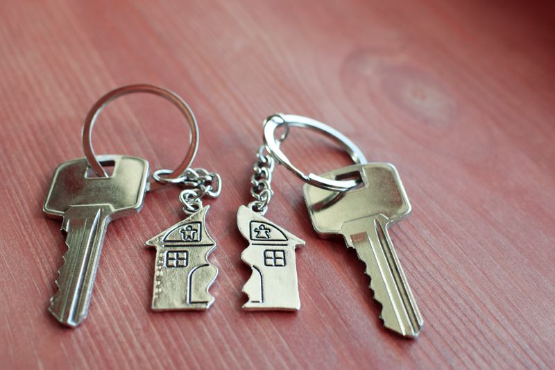 Two keys with split key rings with pendant in shape of house
